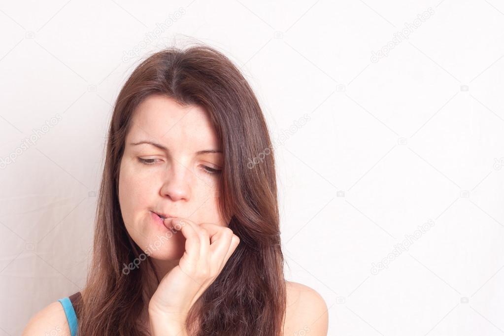 a portrait of a young woman biting her nails