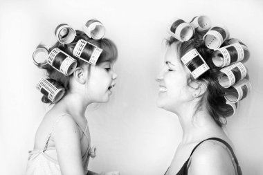 vintage image of a mother and daughter wearing rollers in their hair and having a good time clipart
