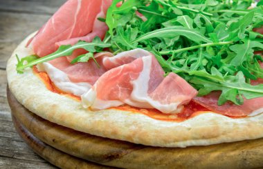 İtalyan pizza jambon ve taze roket salata ile