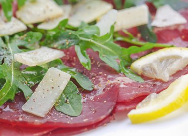 Bresaola with arugula salad and olive oil clipart