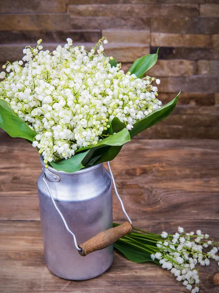 Bouquet of white lilies of the valley in aluminum containers on a wooden background — Stock Photo, Image