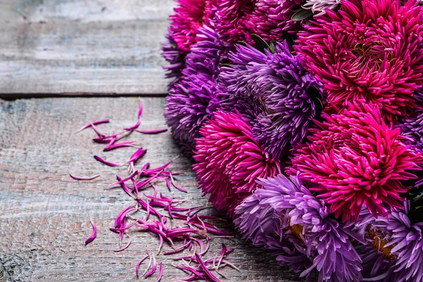 Aster flowers bouquet purple red pink white on a wooden background. selective focus