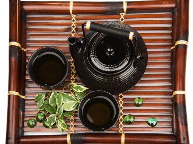 Green tea set on a bamboo mat clipart