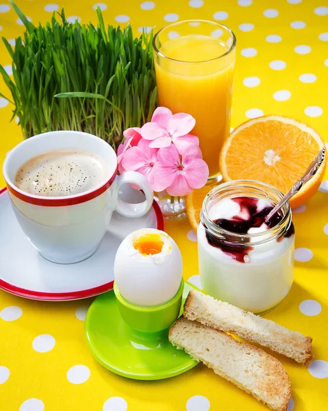 Breakfast including coffee, toast, eggs,  orange juice, muesli, yogurt,  fruits — Stock Photo, Image