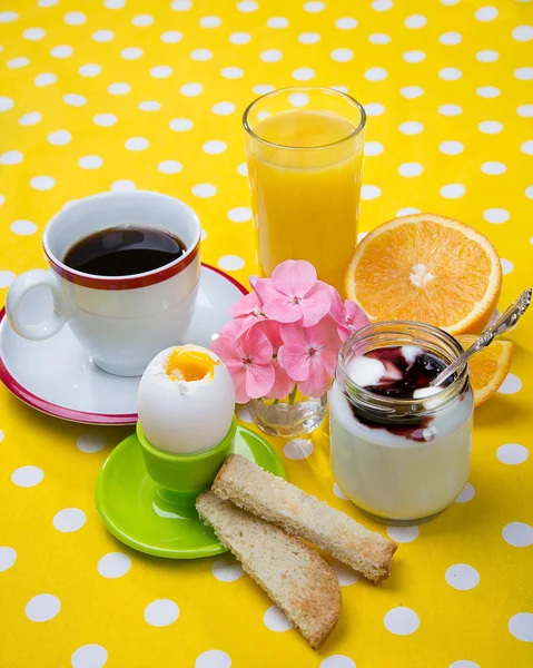 Breakfast including coffee, toast, eggs,  orange juice, muesli, yogurt,  fruits — Stock Photo, Image