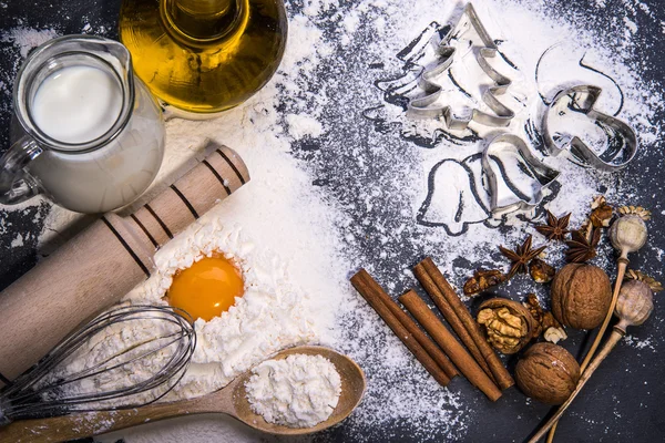 Baking ingredients for making dough: eggs, milk, oil and flour on black board. — Stock Photo, Image