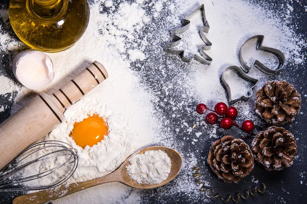 Baking ingredients for making dough: egg and flour on black board. Christmas cookies — Stock Photo, Image