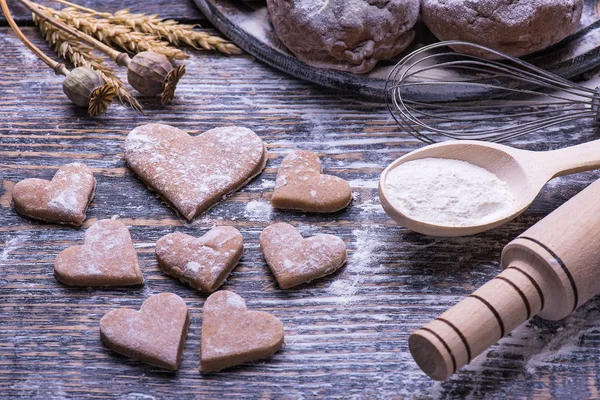 Baking ingredients for making biscuits, cookies in the shape of heart on wooden board. St.Valentine"s Day. — Stock Photo, Image