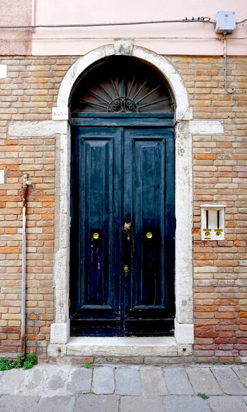 Door on old brick wall building architecture, Venice, Italy