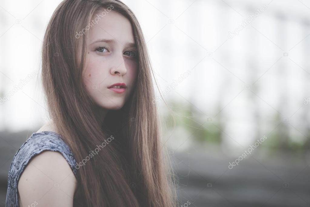 portrait of a beautiful young sad hipster girl  outdoors