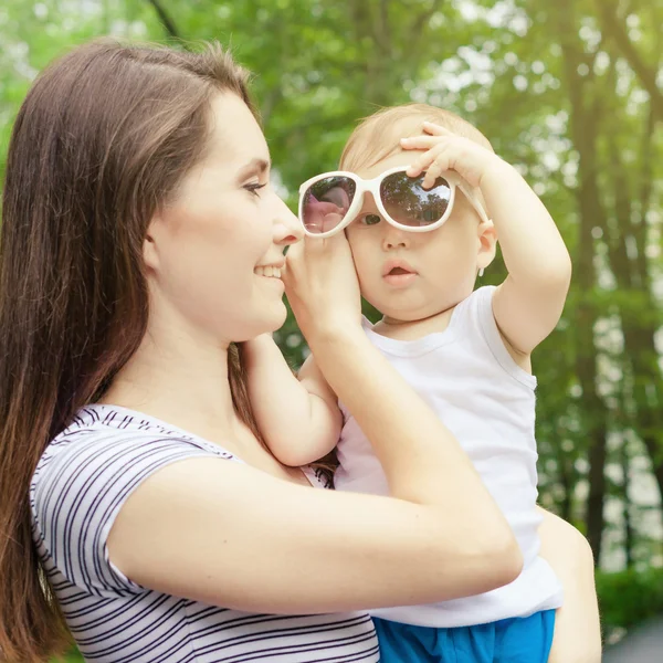 Glad mamma leker med hennes barn i parken — Stockfoto