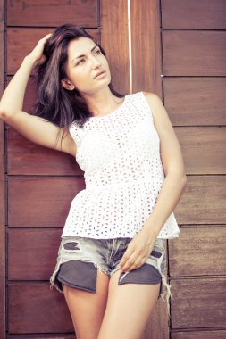 Stunning young woman posing outdoor near door