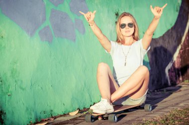 Fashion lifestyle, Beautiful young blonde woman with skateboard 