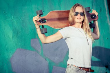 Fashion lifestyle, Beautiful young blonde woman with skateboard 