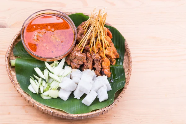 Barbecue satay served on traditional rattan plate with banana leaf — Stock Photo, Image