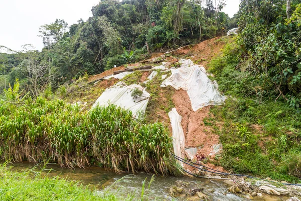 Huge plastic sheets used to temporarily halt slope soil erosion — Stock Photo, Image