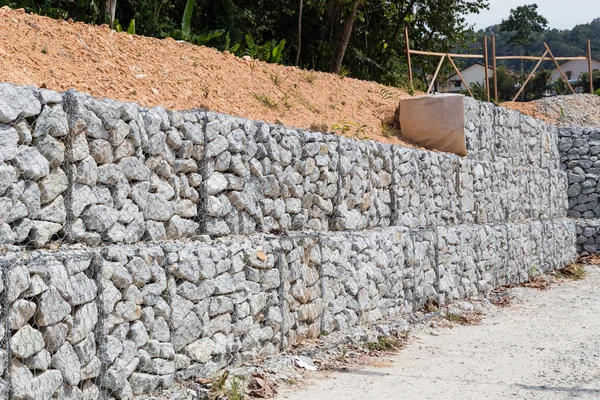 Slope retention management with rocks and wire mesh cage system — Stock Photo, Image