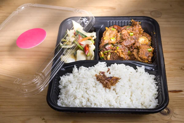 Convenient take-away meal box with rice, meat and vegetable