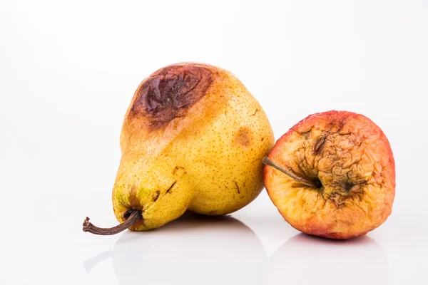 Manzana roja podrida y en descomposición y pera sobre fondo blanco — Foto de Stock