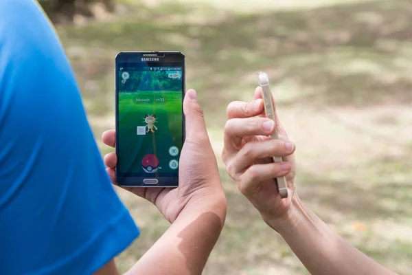 KUALA LUMPUR, MALAYSIA, JULY 24, 2016: Two users play Pokemon Go