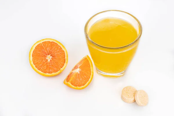 Orange flavored vitamin c effervescent tablet dissolve in glass of water — Stock Photo, Image