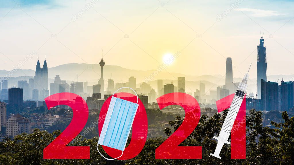 Welcome 2021 text against Kuala Lumpur cityscape with face mask and syringe suggesting Covid-19 vaccination year