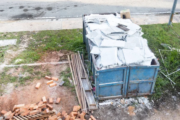 Lixo roro lixeira recolhe lixo no local de construção — Fotografia de Stock