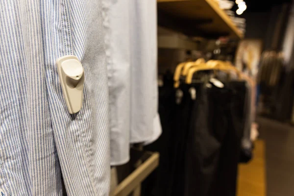 在服装店的围裙上贴上RFID防盗标签的特写 — 图库照片