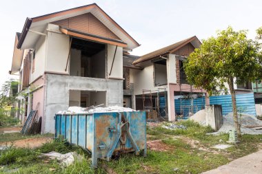 Çöp tenekesi inşaat alanında çöp topluyor.