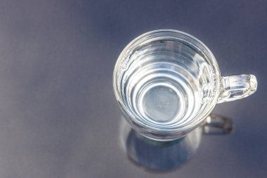 Yüzeydeki şeffaf camlarda hala temiz içme suyu mavi gökyüzüne ve bulutlara karşı yansıyor.