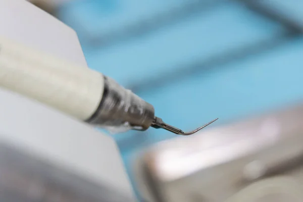 Close-up on dental surgery handpiece burr with sharp tip for scaling