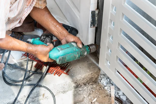 Trabalhador de montagem nova porta grade de metal para edifício residencial com ferramenta de chave de parafuso de alimentação — Fotografia de Stock