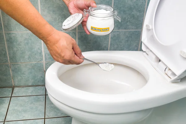 Baking soda used to clean and disinfect bathroom and toilet bowl — Stock Photo, Image