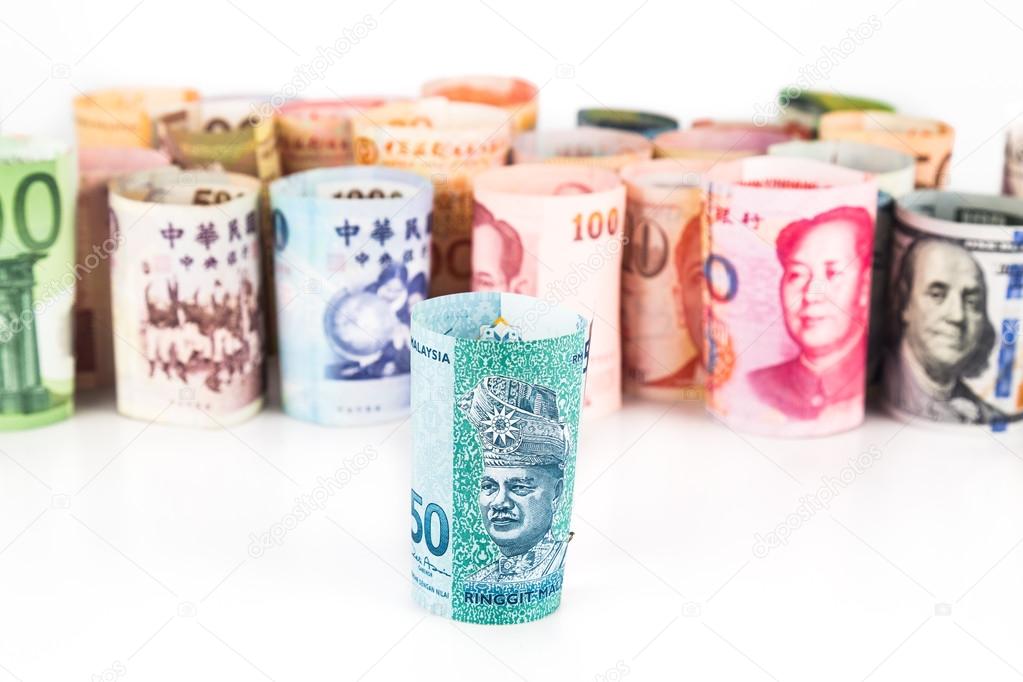 Pile of rolled-up currency notes with Malaysia Ringgit in front