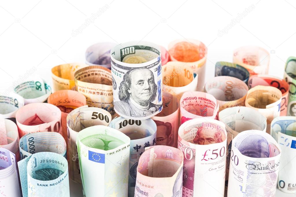 Pile of rolled-up currency notes with US Dollar on top
