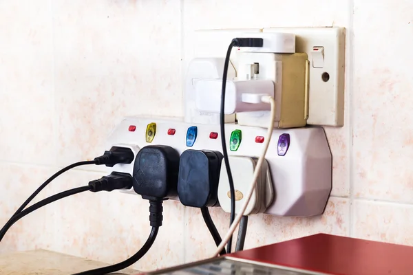 Multiple electricity plugs attached to multi adapter is dangerou — Stock Photo, Image