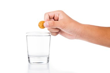 Series of finger dropping effervescent vitamin C tablet into glass of water clipart