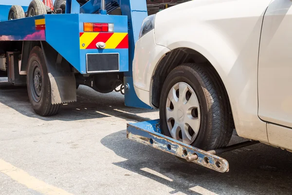 Tow truck towing a broken down car with focus on car being towed. — Stock Photo, Image