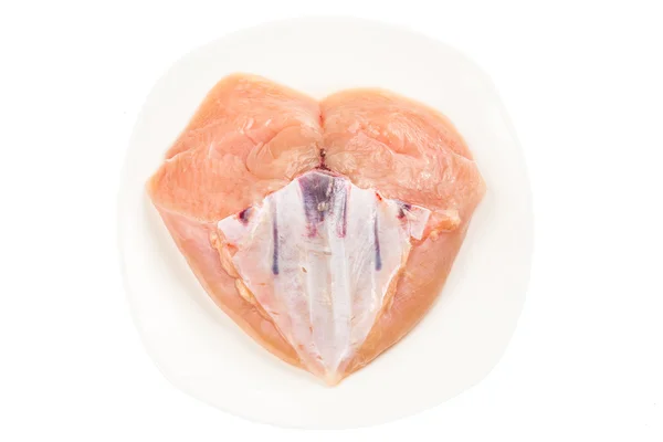 Carne fresca de pechuga de pollo sin piel en forma de corazón con hueso de quilla —  Fotos de Stock