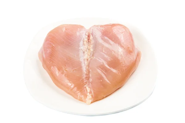Corazón en forma de carne de pechuga de pollo sin piel en un plato —  Fotos de Stock