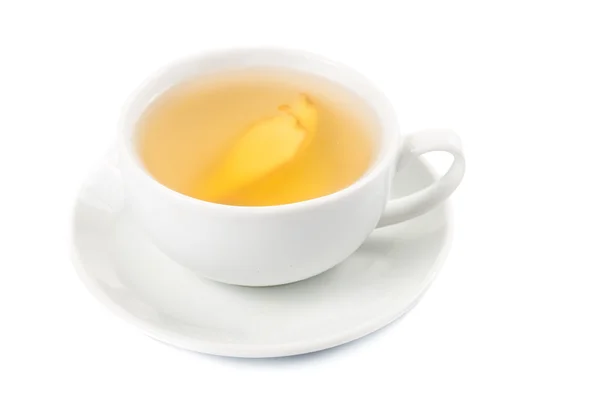 Hot ginger tea in a cup and saucer — Stock Photo, Image