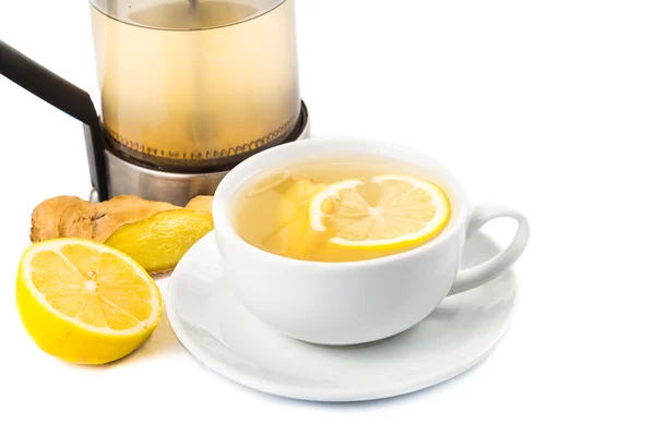 Stimulating hot ginger and lemon tea in a cup and filter jar — Stok Foto