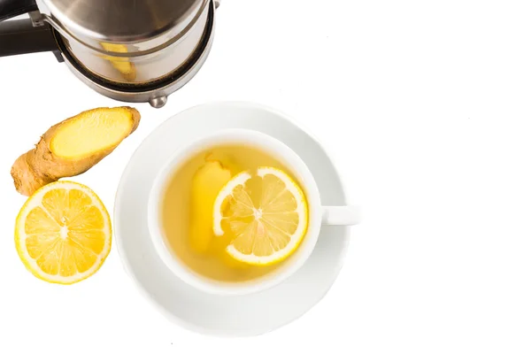 Stimulating hot ginger and lemon tea in a cup and filter jar — Stok Foto