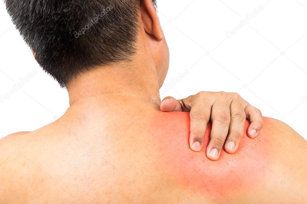 Matured man embracing his painful swollen shoulder with his hand