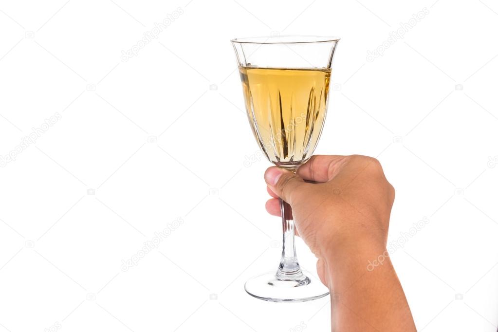 Hand holding white wine in crystal glass and ready to toast