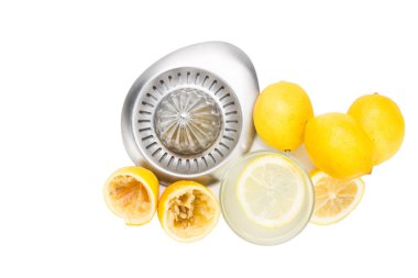 Freshly squeezed organic lemon juice with glass and squeezer.