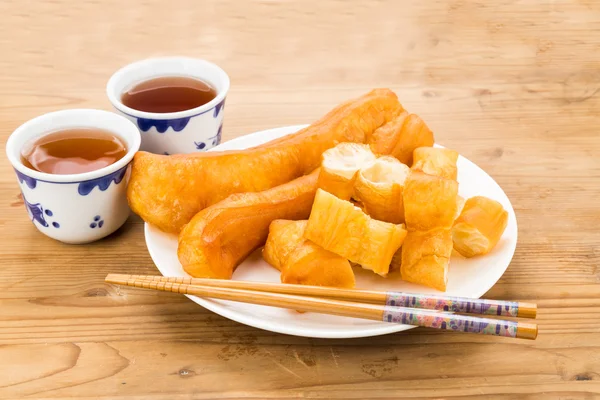 Жареный хлебный палочка или Вы Тиао служил с китайским чаем . — стоковое фото