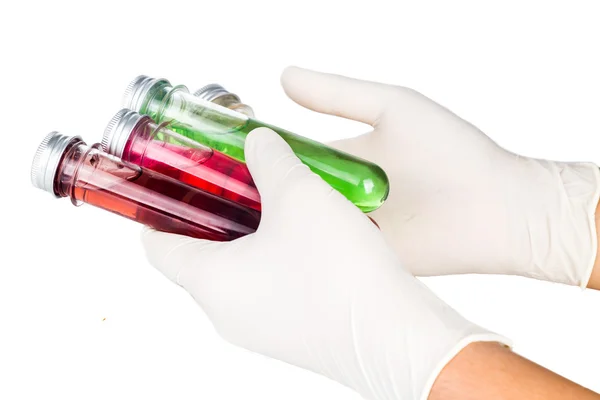 Håndholdte latexhandsker med reagensglas med væske . - Stock-foto