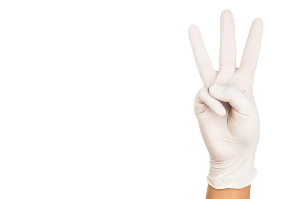 Mano en guante de látex quirúrgico gesto número tres . —  Fotos de Stock