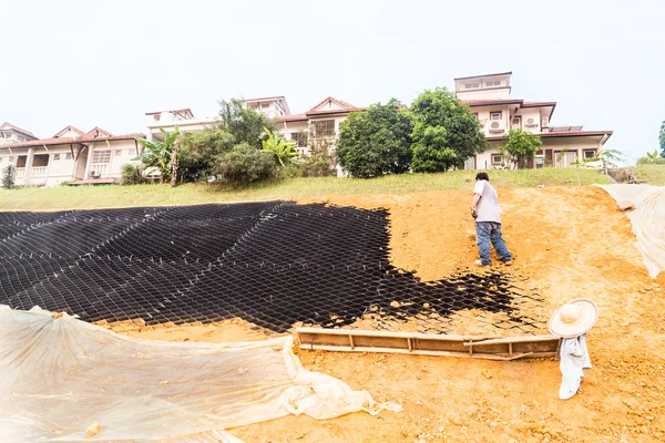 Slope erosion control with grids and earth on steep slope — Stock Photo, Image